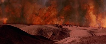 Movie still from “Robinson Crusoe on Mars” (1964), directed by Byron Haskin – A large fire is burning in the desert; Extreme Wide shot, High angle