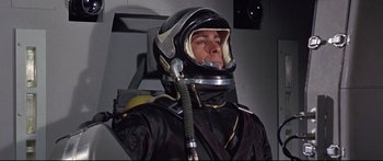 Movie still from “Robinson Crusoe on Mars” (1964), directed by Byron Haskin – A man in a space suit with a helmet on; Medium shot, Low angle