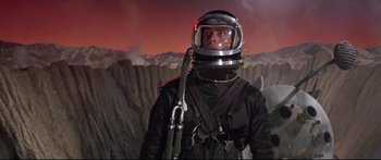 Movie still from “Robinson Crusoe on Mars” (1964), directed by Byron Haskin – A man wearing a space suit and helmet; Medium shot, Low angle