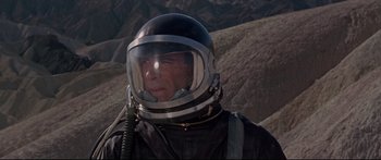 Movie still from “Robinson Crusoe on Mars” (1964), directed by Byron Haskin – A man wearing a space suit and a helmet; Medium shot, High angle