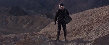 Movie still from “Robinson Crusoe on Mars” (1964), directed by Byron Haskin – A man in a spacesuit standing on top of a mountain; Wide shot, Low angle