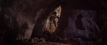 Movie still from “Robinson Crusoe on Mars” (1964), directed by Byron Haskin – A man in a space suit is inside a cave; Wide shot, Low angle