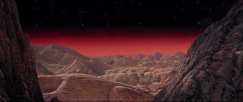 Movie still from “Robinson Crusoe on Mars” (1964), directed by Byron Haskin – An image of a red sky over a mountain range; Extreme Wide shot, High angle