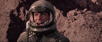 Movie still from “Robinson Crusoe on Mars” (1964), directed by Byron Haskin – A man in a space suit and a helmet; Close Up shot, Low angle