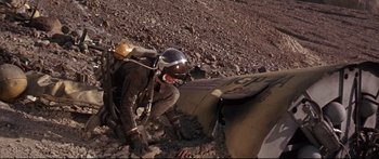 Movie still from “Robinson Crusoe on Mars” (1964), directed by Byron Haskin – A man with a helmet and a backpack on a hill; Wide shot, High angle