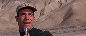 Movie still from “Robinson Crusoe on Mars” (1964), directed by Byron Haskin – A person holding a cell phone in his hand; Close Up shot, Low angle