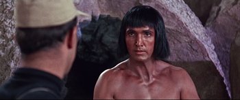 Movie still from “Robinson Crusoe on Mars” (1964), directed by Byron Haskin – A man with long black hair looking at himself in a mirror; Close Up shot, Over the shoulder angle