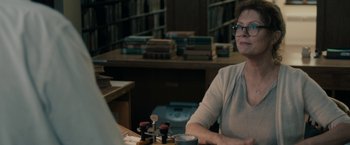 Movie still from “Robot & Frank” (2012), directed by Jake Schreier – A woman sitting at a table in a library; Close Up shot, Over the shoulder angle