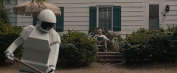 Movie still from “Robot & Frank” (2012), directed by Jake Schreier – An older man sitting on a porch reading a book; Wide shot, Over the shoulder angle