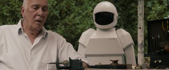 Movie still from “Robot & Frank” (2012), directed by Jake Schreier – A man sitting next to a white robot; Medium shot, Over the shoulder angle