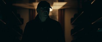 Movie still from “Robot & Frank” (2012), directed by Jake Schreier – A man wearing a hat and a black jacket; Close Up shot, Low angle