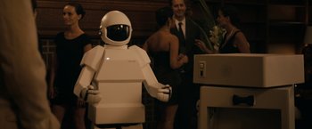 Movie still from “Robot & Frank” (2012), directed by Jake Schreier – A robot that is standing in front of some people; Medium shot, Over the shoulder angle