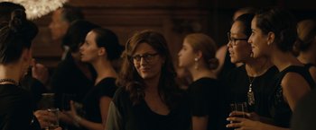 Movie still from “Robot & Frank” (2012), directed by Jake Schreier – A group of women standing next to each other in a room; Close Up shot, Over the shoulder angle