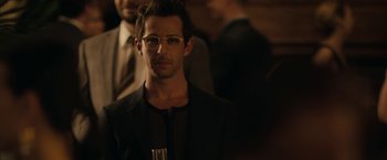 Movie still from “Robot & Frank” (2012), directed by Jake Schreier – A man in a black suit and white glasses; Close Up shot, Over the shoulder angle