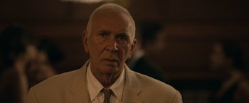 Movie still from “Robot & Frank” (2012), directed by Jake Schreier – An older man wearing a suit and tie; Close Up shot, Over the shoulder angle