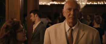 Movie still from “Robot & Frank” (2012), directed by Jake Schreier – An older man wearing a suit and tie in front of a mirror; Close Up shot, Over the shoulder angle
