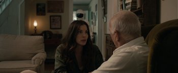 Movie still from “Robot & Frank” (2012), directed by Jake Schreier – An older man talking to a young woman in front of a mirror; Medium shot, Over the shoulder angle