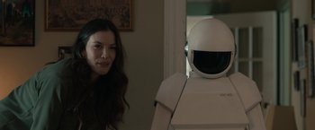 Movie still from “Robot & Frank” (2012), directed by Jake Schreier – A woman standing in front of a white robot; Medium shot, Over the shoulder angle