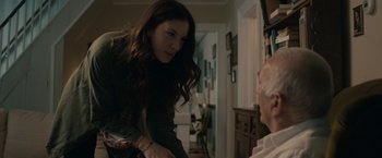 Movie still from “Robot & Frank” (2012), directed by Jake Schreier – A woman is talking to an older man in a living room; Medium shot, Over the shoulder angle