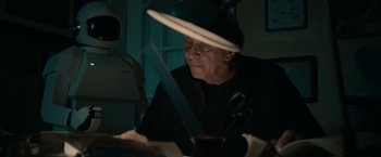 Movie still from “Robot & Frank” (2012), directed by Jake Schreier – An older man sitting at a table in front of a computer; Medium shot, Low angle