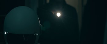 Movie still from “Robot & Frank” (2012), directed by Jake Schreier – A person is standing in the dark with a flashlight in their hand; Close Up shot, Low angle