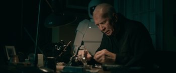 Movie still from “Robot & Frank” (2012), directed by Jake Schreier – An older man working on a project in a darkroom; Close Up shot, Low angle