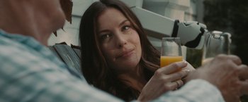 Movie still from “Robot & Frank” (2012), directed by Jake Schreier – A beautiful woman holding a glass of orange juice; Close Up shot, Over the shoulder angle