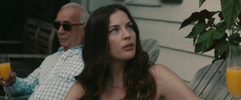 Movie still from “Robot & Frank” (2012), directed by Jake Schreier – A beautiful woman with long brown hair sitting in a chair; Close Up shot, Over the shoulder angle
