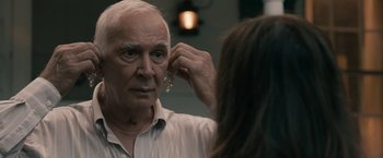 Movie still from “Robot & Frank” (2012), directed by Jake Schreier – An older man putting on a pair of earrings; Close Up shot, Over the shoulder angle