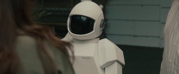 Movie still from “Robot & Frank” (2012), directed by Jake Schreier – A person in a white suit is looking at something in the background; Medium shot, Over the shoulder angle