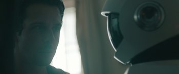 Movie still from “Robot & Frank” (2012), directed by Jake Schreier – A man is looking at a person wearing a helmet; Close Up shot, Over the shoulder angle