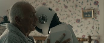 Movie still from “Robot & Frank” (2012), directed by Jake Schreier – An old man kissing a robot on the cheek; Close Up shot, Over the shoulder angle