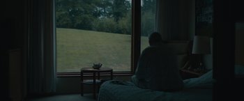 Movie still from “Robot & Frank” (2012), directed by Jake Schreier – A man sitting on a bed looking out of a window; Wide shot, High angle