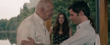 Movie still from “Robot & Frank” (2012), directed by Jake Schreier – Two men and a woman standing next to each other in front of trees; Medium shot, Over the shoulder angle