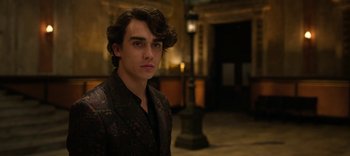 Movie still from “13 Reasons Why” (2017), created by Brian Yorkey – A young man in a black and brown jacket; Close Up shot, Over the shoulder angle