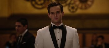 Movie still from “13 Reasons Why” (2017), created by Brian Yorkey – A man in a white suit with a black bow tie; Close Up shot, Over the shoulder angle