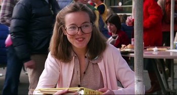 Movie still from “Rock 'n' Roll High School” (1979), directed by Joe Dante – A woman sitting at a table with a book in front of her; Close Up shot, Low angle