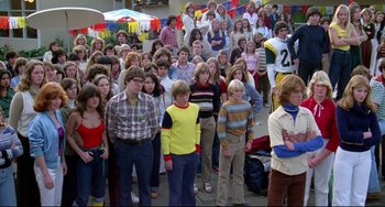 Movie still from “Rock 'n' Roll High School” (1979), directed by Joe Dante – A group of people standing in front of each other; Wide shot, High angle