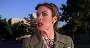 Movie still from “Rock 'n' Roll High School” (1979), directed by Joe Dante – A person wearing a suit and tie; Close Up shot, Low angle