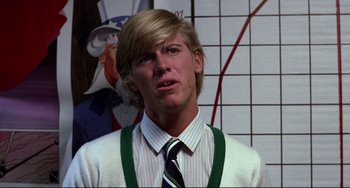 Movie still from “Rock 'n' Roll High School” (1979), directed by Joe Dante – A man with blonde hair wearing a white shirt and a green tie; Close Up shot, Low angle