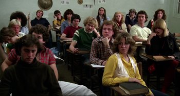 Movie still from “Rock 'n' Roll High School” (1979), directed by Joe Dante – A group of people sitting in a classroom; Medium shot, High angle