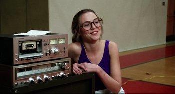 Movie still from “Rock 'n' Roll High School” (1979), directed by Joe Dante – A woman sitting in front of an old fashioned radio; Close Up shot, Over the shoulder angle