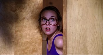 Movie still from “Rock 'n' Roll High School” (1979), directed by Joe Dante – A young girl wearing glasses looking out a window; Close Up shot, Low angle