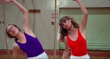 Movie still from “Rock 'n' Roll High School” (1979), directed by Joe Dante – Two women are doing different exercises in a gym; Medium shot, Low angle