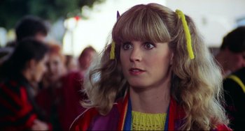 Movie still from “Rock 'n' Roll High School” (1979), directed by Joe Dante – A person wearing a yellow shirt; Close Up shot, Over the shoulder angle