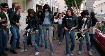 Movie still from “Rock 'n' Roll High School” (1979), directed by Joe Dante – A group of young men walking down a sidewalk; Wide shot, Low angle