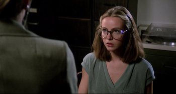 Movie still from “Rock 'n' Roll High School” (1979), directed by Joe Dante – A woman wearing glasses looking into the camera; Close Up shot, Over the shoulder angle