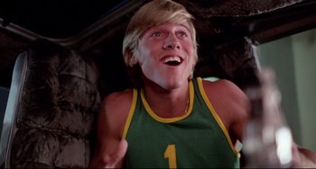 Movie still from “Rock 'n' Roll High School” (1979), directed by Joe Dante – A man with blonde hair and a green shirt is laughing; Close Up shot, Low angle