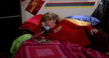 Movie still from “Rock 'n' Roll High School” (1979), directed by Joe Dante – A woman laying in bed talking on a phone; Medium shot, Overhead angle