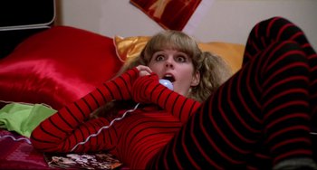 Movie still from “Rock 'n' Roll High School” (1979), directed by Joe Dante – A woman laying on a bed holding a phone to her ear; Medium shot, Overhead angle